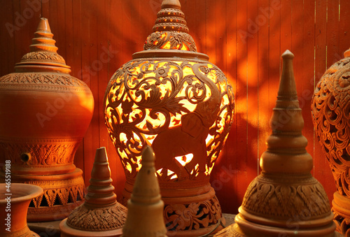 Orange brown unglazed terracotta Lamp with an intricate patterns of Koh Kret pottery, Koh Kret Island, Thailand photo