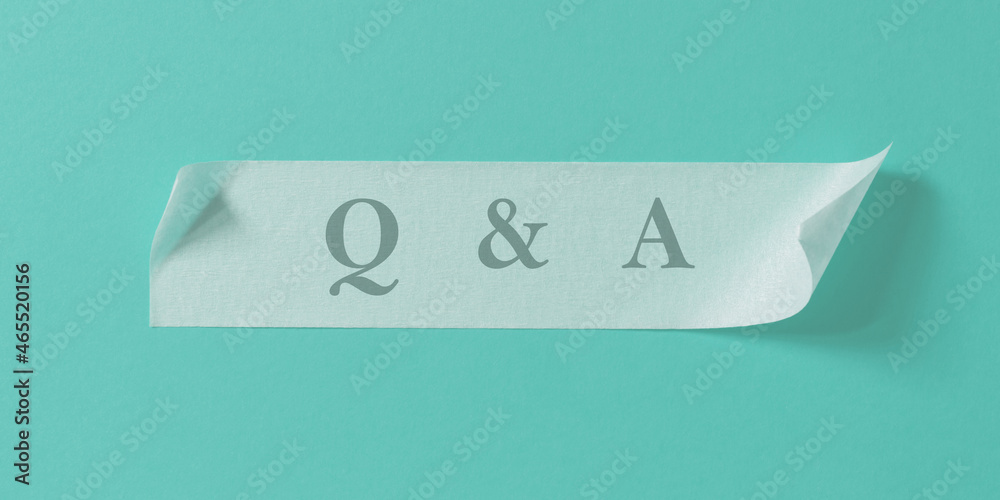 Letters Q and A written on strip of masking tape stuck to turquoise