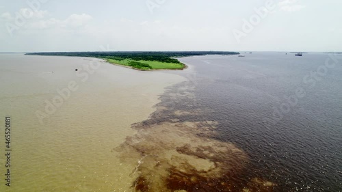 The confluence of two dark and light waters of the Encontro das Aguas and Rio Negro straits.