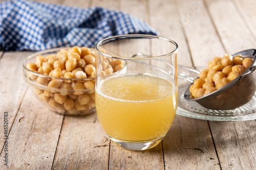 Chickpea water aquafaba on wooden table. Chickpea water is a substitute for eggs in pastries photo