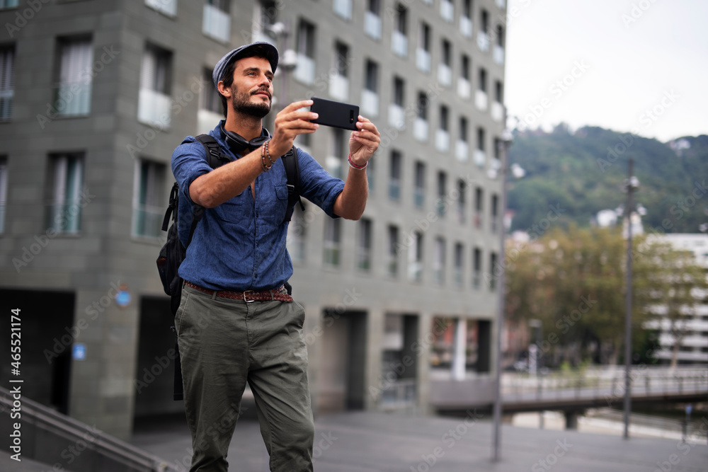 Young stylish man using the phone outdoors. Fashion happy businessman outdoors. Young stylish man using the phone outdoors. Fashion happy businessman outdoors.