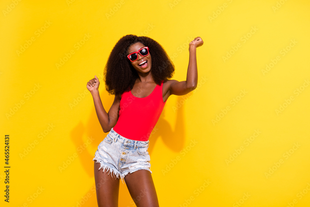 Portrait of attractive cheerful cool girl having fun dancing pastime chill out good mood isolated over bright yellow color background Portrait of attractive cheerful cool girl having fun dancing pastime chill out good mood isolated over bright yellow color background