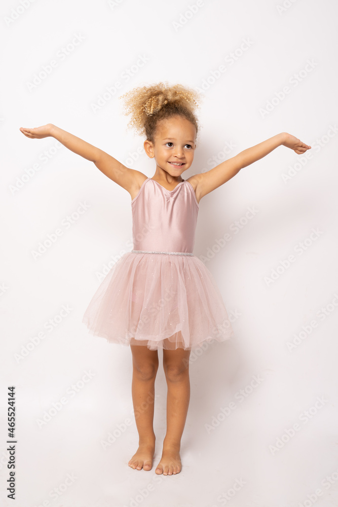 Naklejka premium The little ballerina getting ready for class isolated over white background.