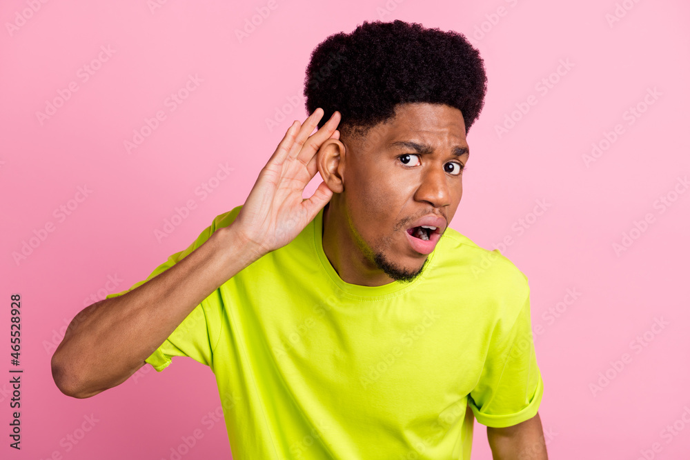 Photo of unhappy young dark skin man hold finger head ear listen rumor isolated on pink color background Photo of unhappy young dark skin man hold finger head ear listen rumor isolated on pink color background