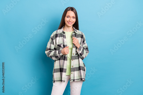 Photo of young attractive pretty girl happy positive smile wear casual outfit isolated over blue color background © deagreez
