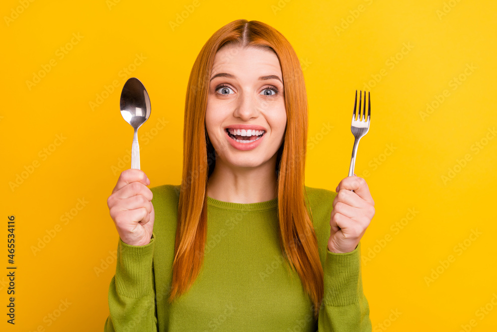 Photo of impressed red hairdo millennial lady want eat wear green jumper isolated on yellow color background Photo of impressed red hairdo millennial lady want eat wear green jumper isolated on yellow color background