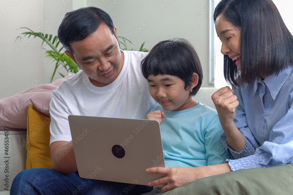 Parents teach their children to use a laptop computer or use it to study online.