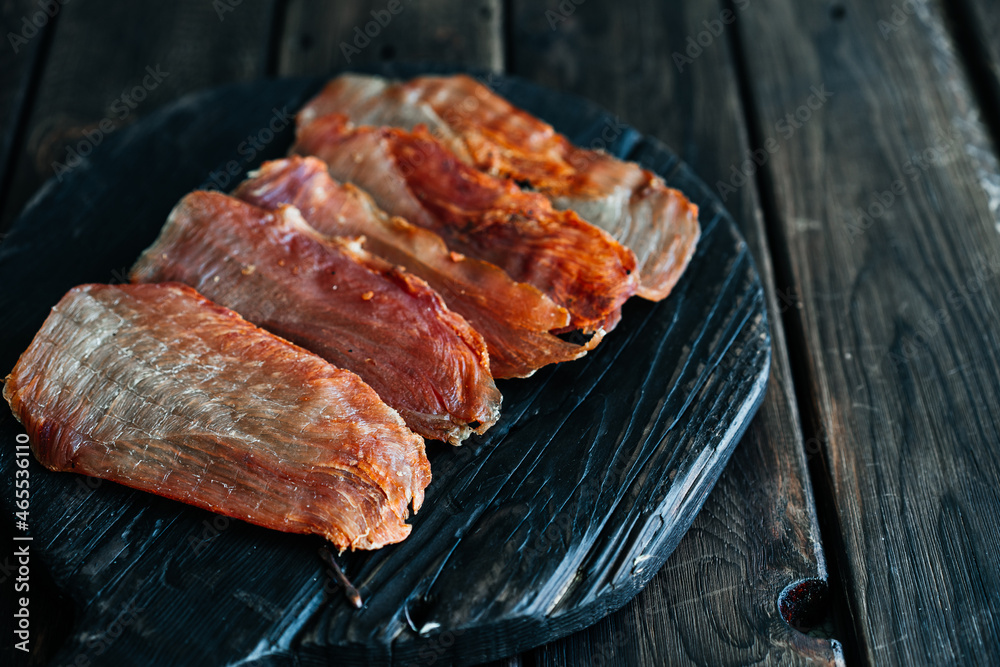 Dried chicken cut into slices on a wooden board. High quality photo Dried chicken cut into slices on a wooden board. High quality photo