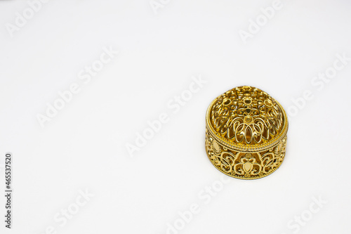 Golden gift box on white background with copy space space.