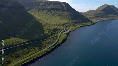Beautiful cinematic aerial footage of the small ferry pier and town if Sydradalur in Kalsoy, on the Faroe Islands