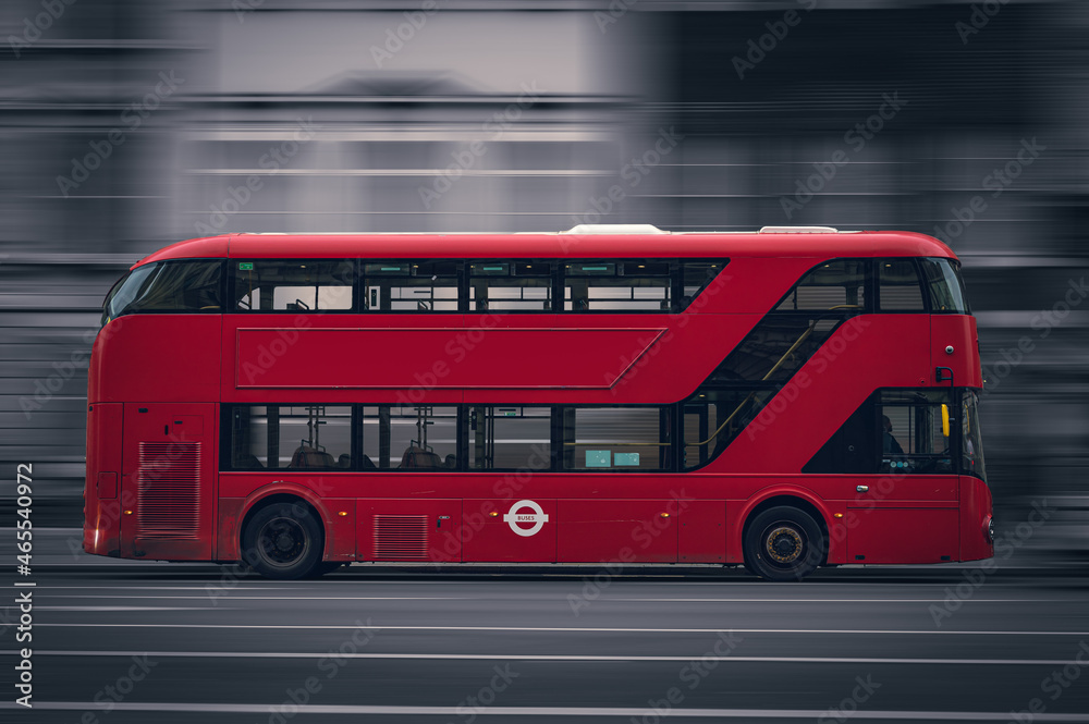 New Routemaster red doubledecker bus in Motion in London from the side