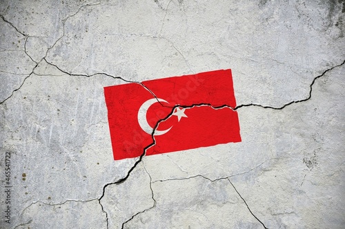 An old image of the flag of Turkey on a wall with a crack.