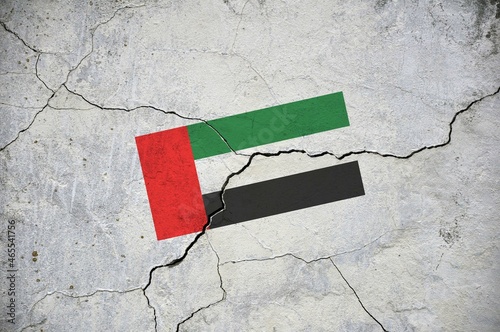 An old image of the flag of United Arab Emirates on a wall with a crack.