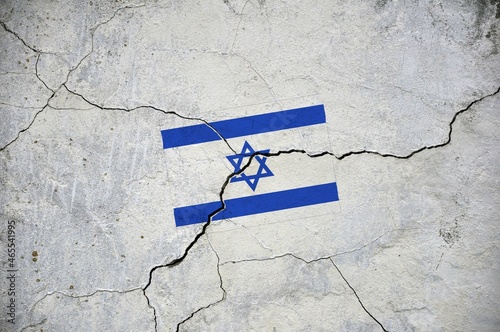 An old image of the flag of Israel on a wall with a crack.