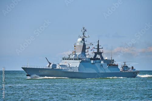Photo Battleship war ship boat corvette with helicopter on deck in beautiful blue sea
