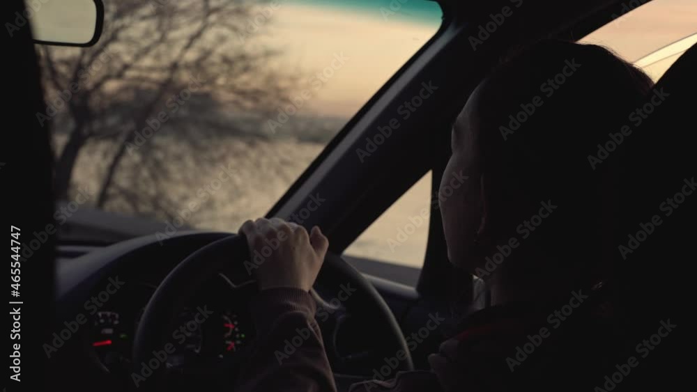 Woman drives a car with her hands on the steering wheel in the city. Shooting from inside the car. Woman drives a car with her hands on the steering wheel in the city. Shooting from inside the car.