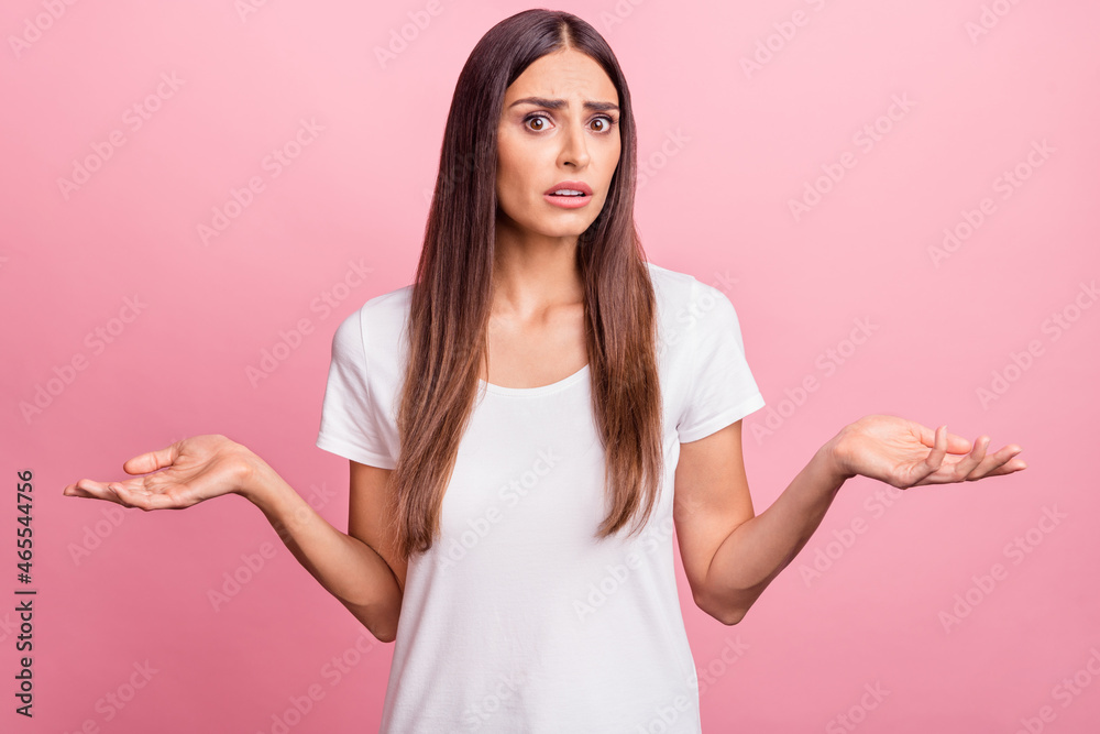 Photo of unsure millennial brunette lady shrug shoulders wear white t-shirt isolated on pink color background Photo of unsure millennial brunette lady shrug shoulders wear white t-shirt isolated on pink color background
