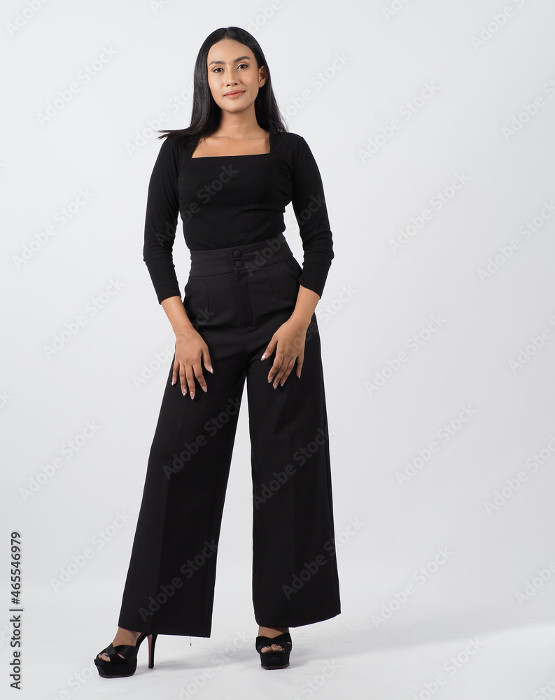 Asian woman full body. Thai woman in a modern chic style stands in white studio with elegant and confident pose. Casting model supporting actor actress. Asian woman fullbody pose in front of camera. Asian woman full body. Thai woman in a modern chic style stands in white studio with elegant and confident pose. Casting model supporting actor actress. Asian woman fullbody pose in front of camera.