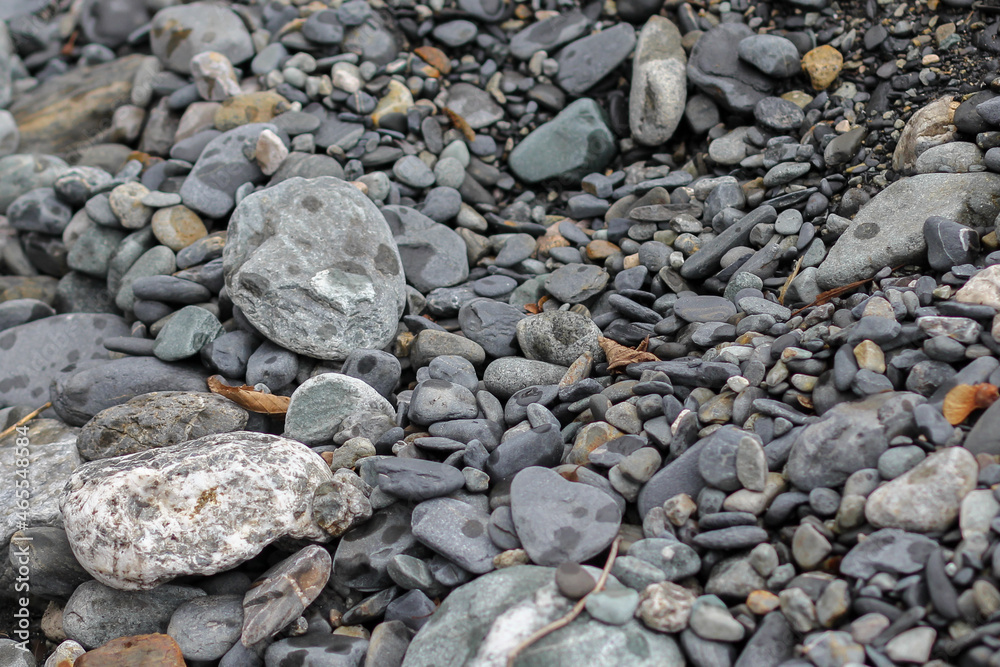Different size stones on land of the river beach