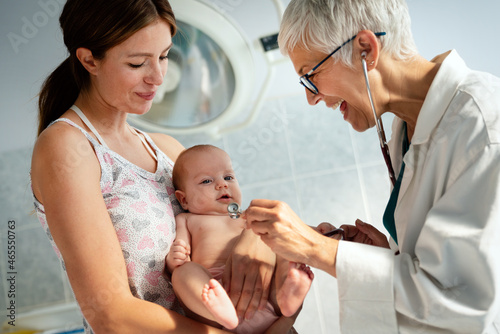 Wallpaper Mural Mother holding baby for pediatrician doctor to examine Torontodigital.ca