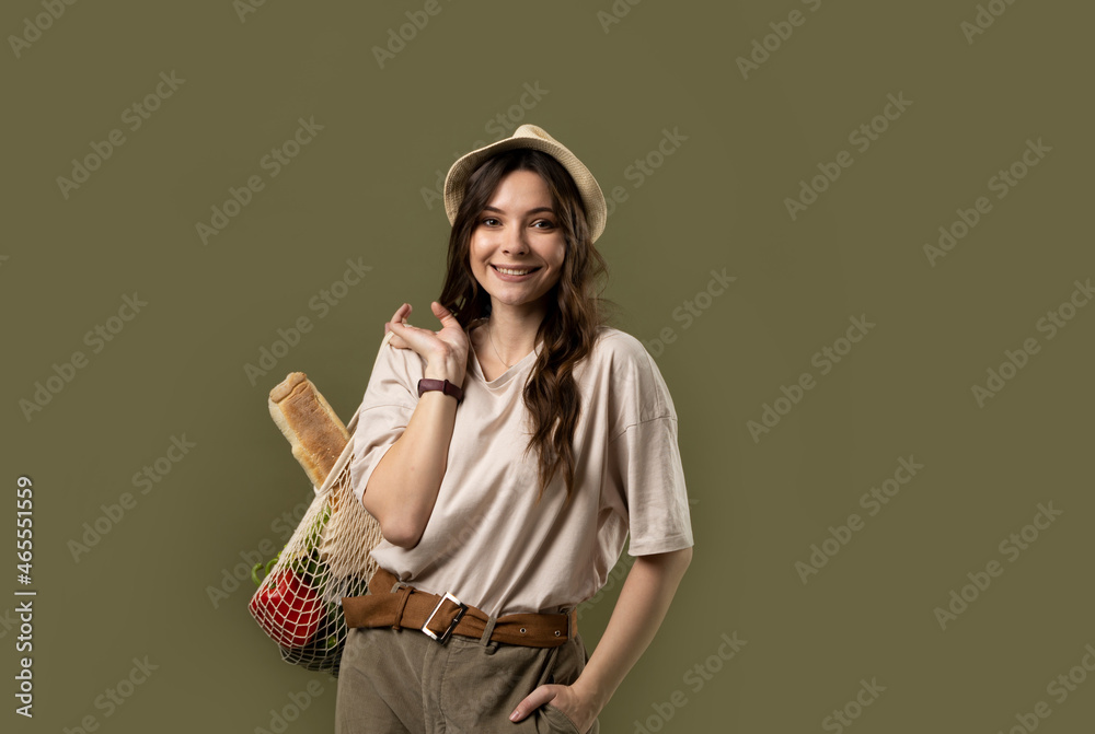 Young woman holding mesh grocery bag with vegetables Concept of no plastic. Zero waste, plastic free. Eco friendly concept. Sustainable lifestyle. Young woman holding mesh grocery bag with vegetables Concept of no plastic. Zero waste, plastic free. Eco friendly concept. Sustainable lifestyle.
