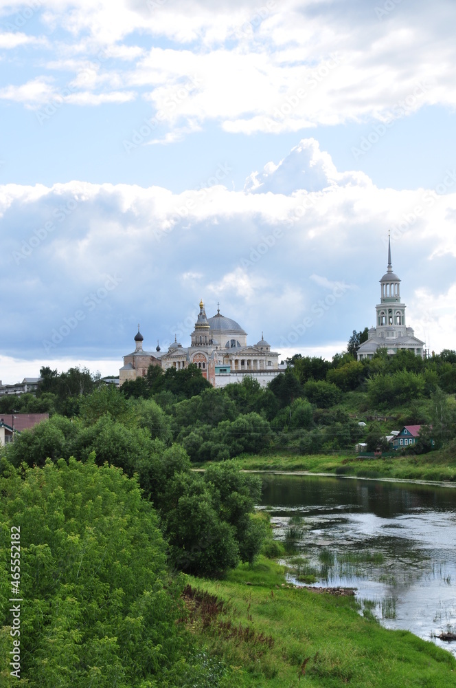 Panoramic view of the river and the old monastery. Clouds in the autumn sky.