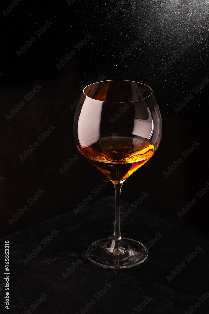 A glass of rose wine on a black background A glass of rose wine on a black background