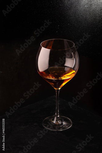 A glass of rose wine on a black background