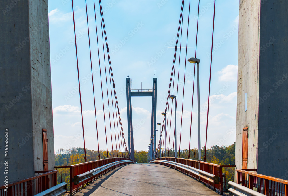 Fototapeta premium Bridge over the water. Support poles and cables. Construction, architecture and infrastructure of road bridges.