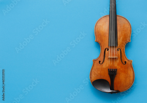 Classical music concert poster with brown color violin on blue background with copy space for your text
