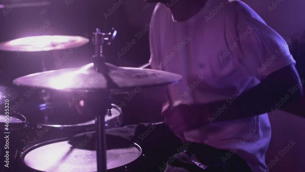 Male Artist hits snare drum, drum kit. Night show in a musical instrument recording studio. The drummer on the Repetition of rock or metal music band. Musical party. Slow motion Male Artist hits snare drum, drum kit. Night show in a musical instrument recording studio. The drummer on the Repetition of rock or metal music band. Musical party. Slow motion
