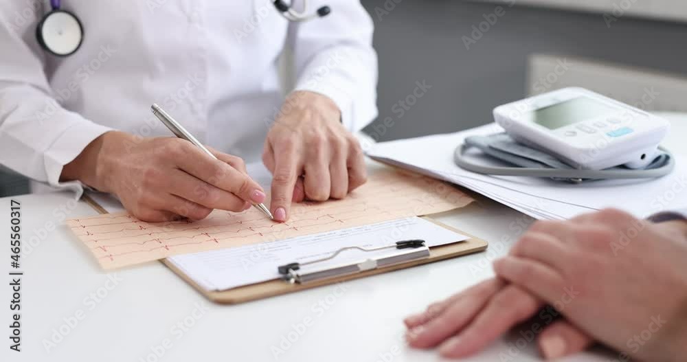 Doctor cardiologist examines cardiogram of heart of sick patient 4k movie Doctor cardiologist examines cardiogram of heart of sick patient 4k movie