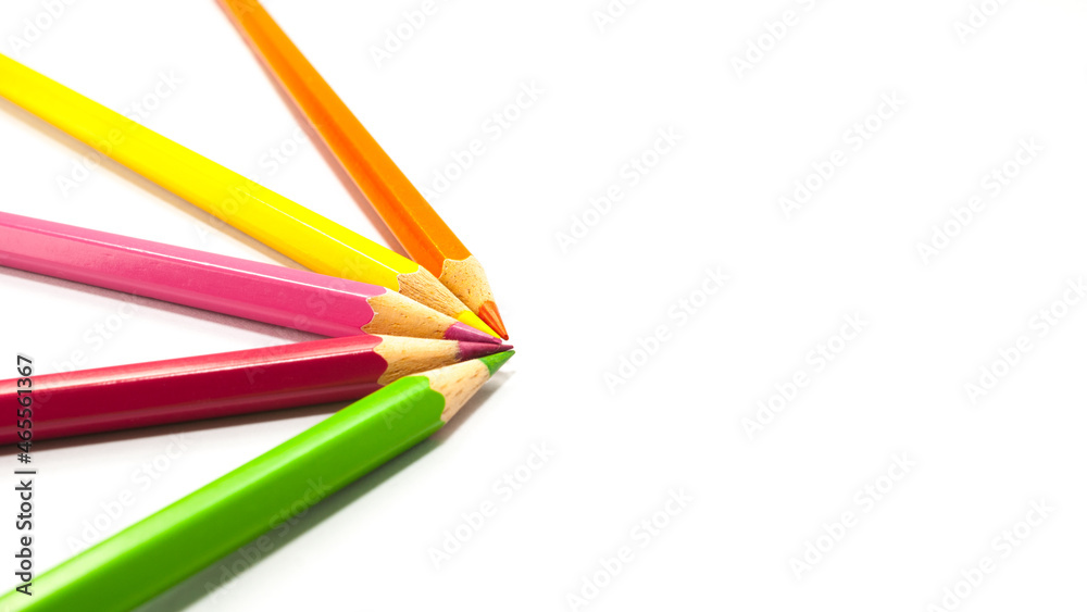 A group of brightly colored pencils placed creatively on a white background.concept art design copy space school and office A group of brightly colored pencils placed creatively on a white background.concept art design copy space school and office