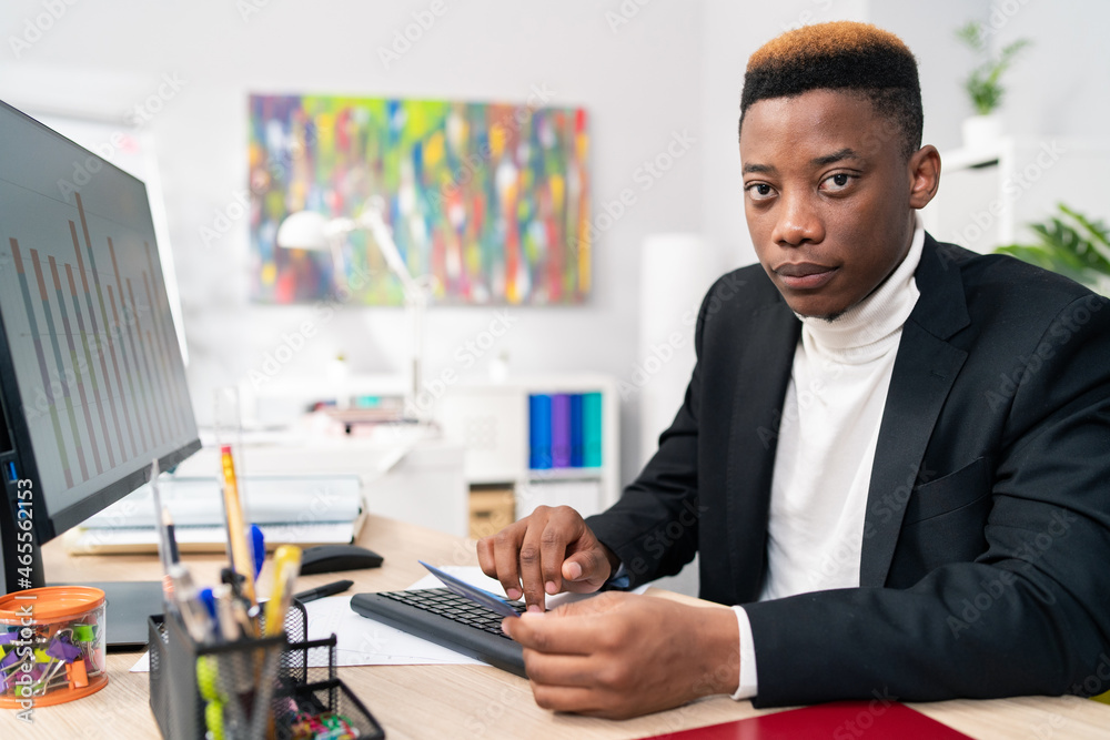 Office worker sales department dark skinned men sit at desk in
