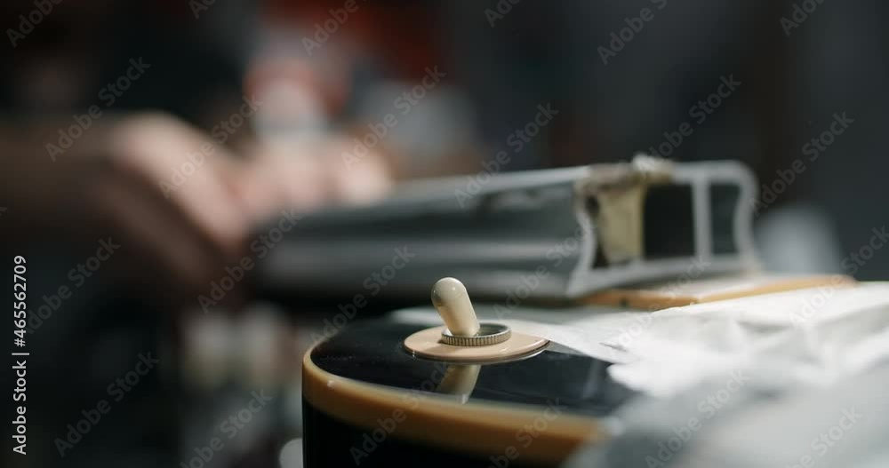 Luthier sands guitar fretboard at musical instruments repair shop, straighten the guitar fretboard, 4k 60fps 10 bit Luthier sands guitar fretboard at musical instruments repair shop, straighten the guitar fretboard, 4k 60fps 10 bit