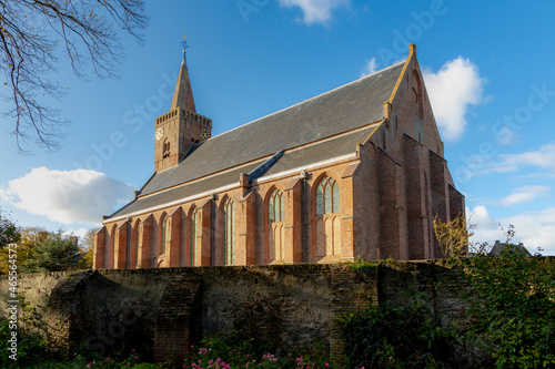 Protestant church (De Burghtkerk ) with blue sky and white cloulds as background, Binnenburg 2, Den Burg, Texel, Dutch Wadden islands off the coast of the Netherlands, North Holland.