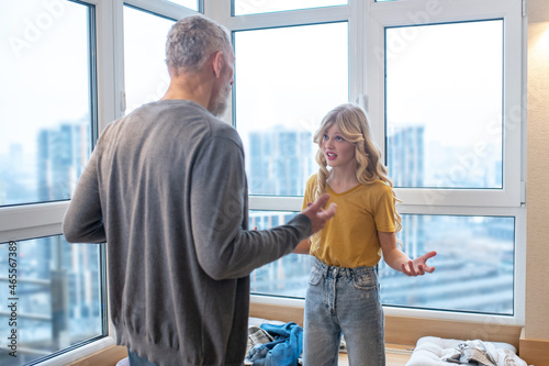 Tableau sur toile A blonde girl feeling upset while having an argument with her dad