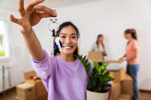 Portrait of young woman holding keys of her new home.
