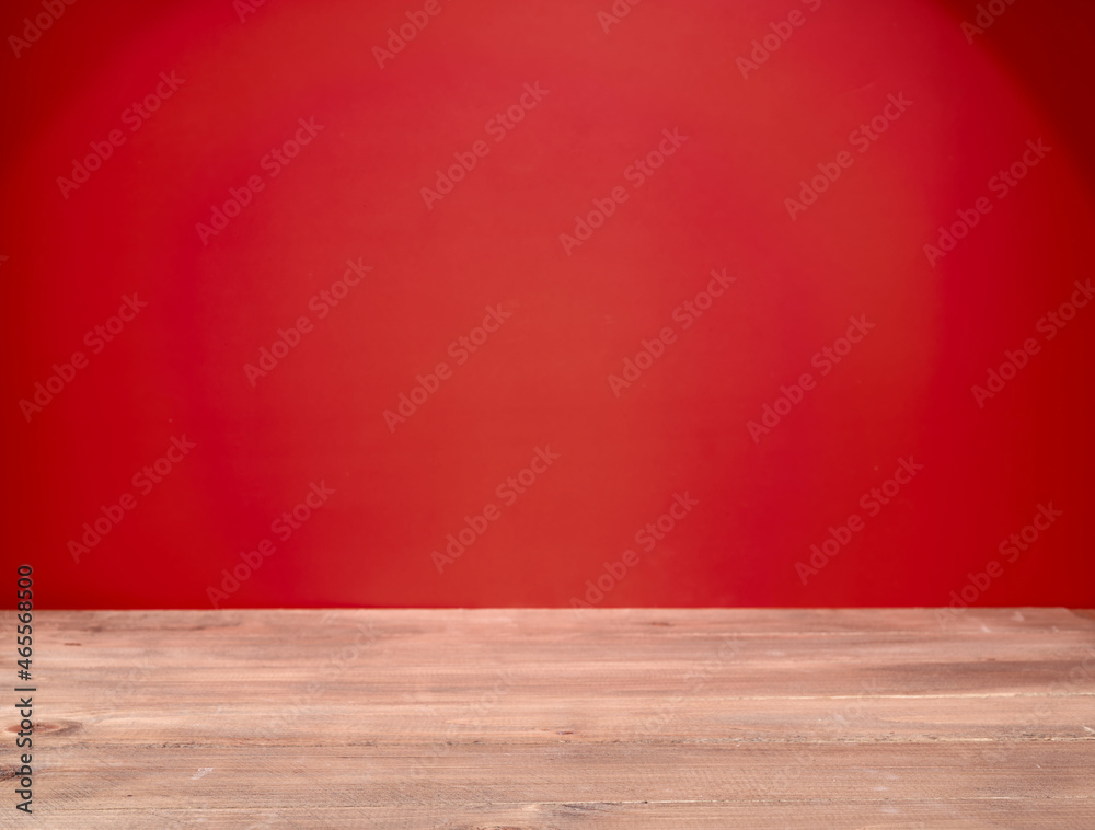 Empty wooden table on red background Empty wooden table on red background