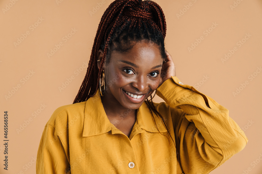 Young black woman with afro pigtails smiling and looking at camera Young black woman with afro pigtails smiling and looking at camera