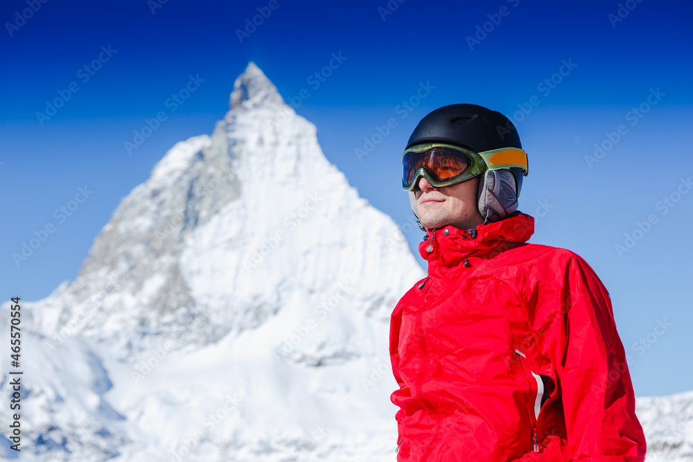 Happy man snowboarder posing with mountain landscape Happy man snowboarder posing with mountain landscape