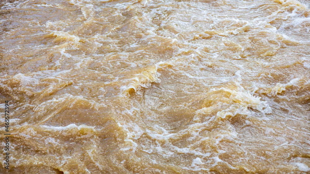 Background of turbid brown tidal wave surface which turbulently floods the overflow weirs. Background of turbid brown tidal wave surface which turbulently floods the overflow weirs.