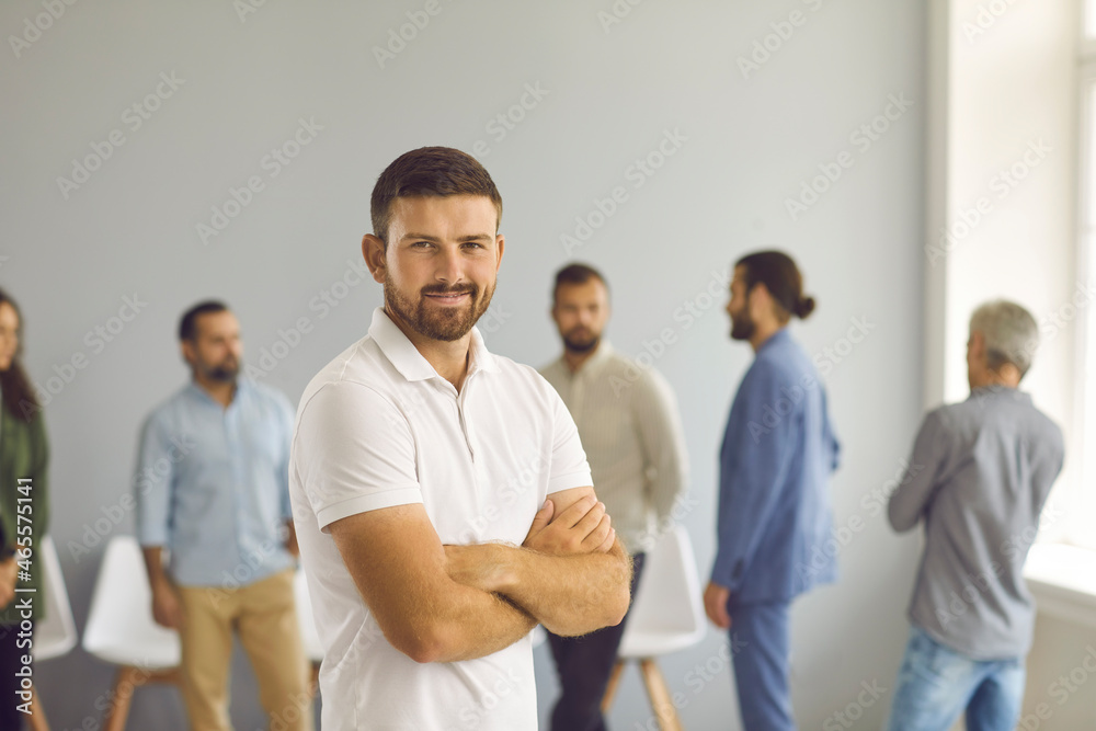 Confident young Caucasian businessman or entrepreneur stand forefront in company business office. Smiling successful millennial generation Z male employee or worker show leadership. Career concept. Confident young Caucasian businessman or entrepreneur stand forefront in company business office. Smiling successful millennial generation Z male employee or worker show leadership. Career concept.
