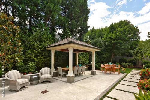 Backyard garden gazebo, tables, and chairs photo