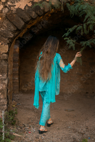 Back view of a girl in Pakistani dress standing in Rohtas Fort photo