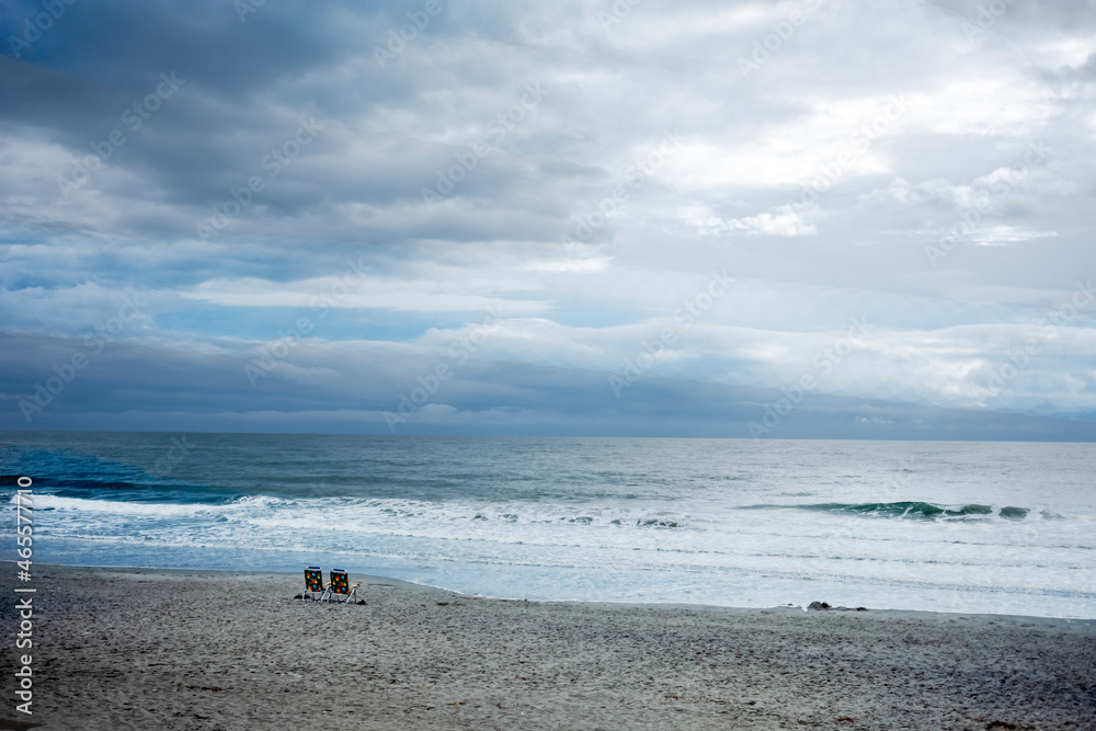 two empty chairs on beach in the morning two empty chairs on beach in the morning