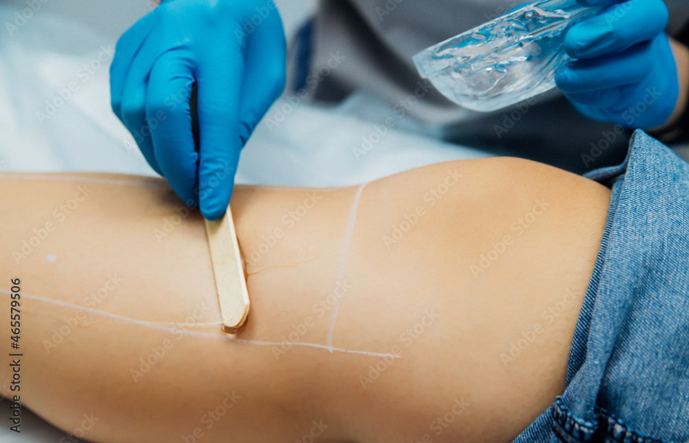 Fototapeta premium Application of contact transparent gel before the laser hair removal procedure. Skin care, cosmetic procedures.