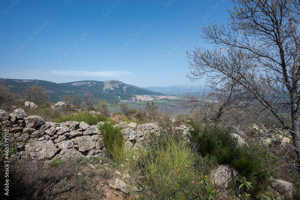 Views of the cities of San Lorenzo de El Escorial and El Escorial from the Bosque de La Herreria, a Natural Park in the province of Madrid, Spain
