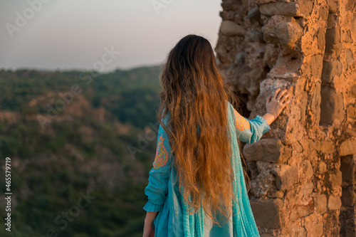 Back view of a girl in Pakistani dress standing in Rohtas Fort