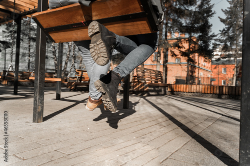 couple riding a swing on the street in the city